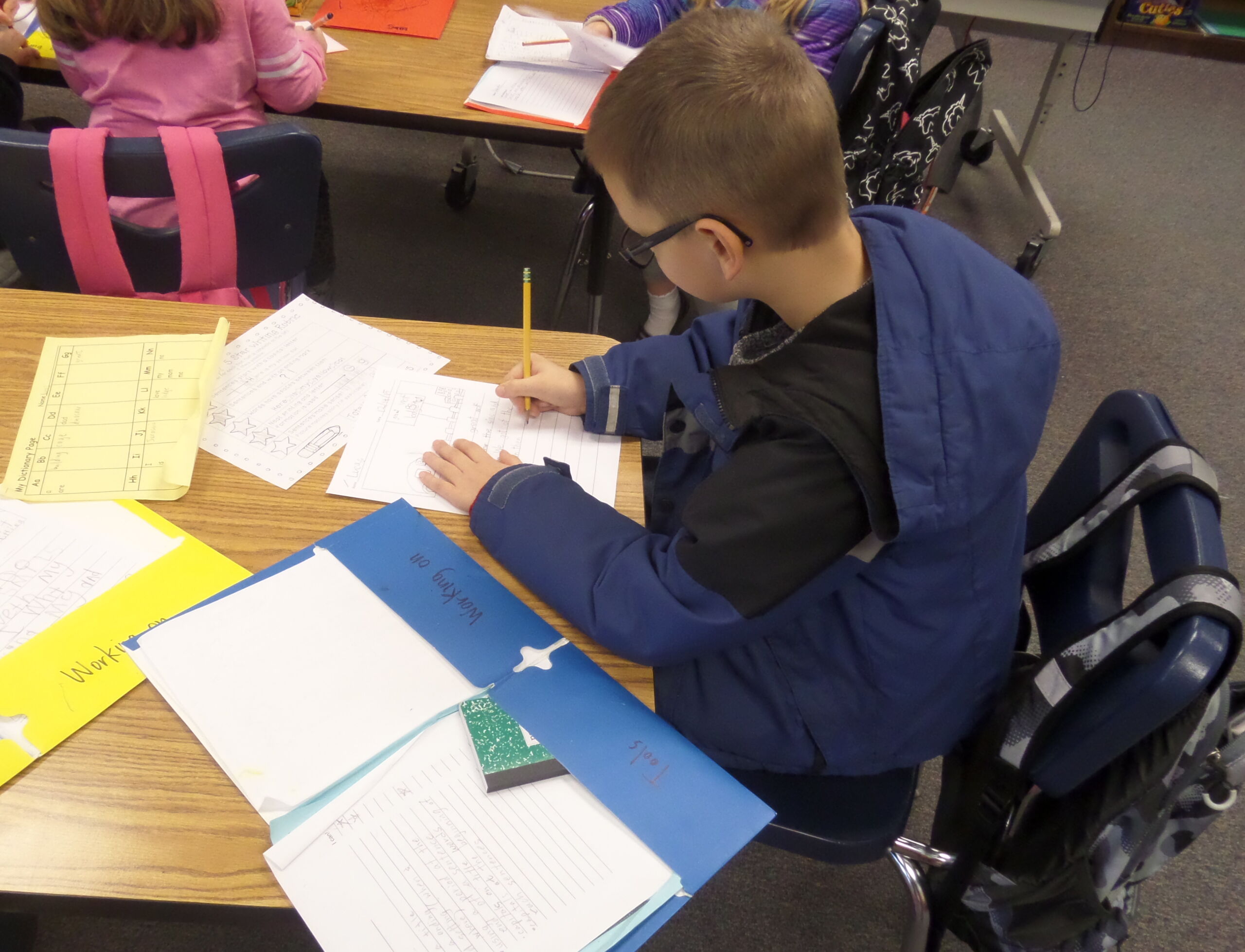 A child in class works on an assignment